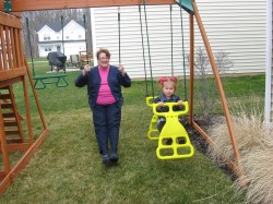 Isabella and Grandma swinging together.