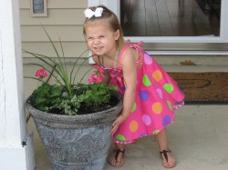Showing off the flowers she helped to plant.